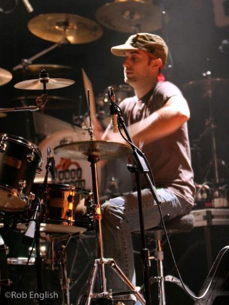 B.J. Caplli drumming on stage.